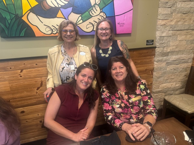 Women smiling at a WINK meeting